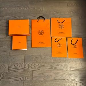 Set of two Hermes gift boxes with ribbons and four shopping bags